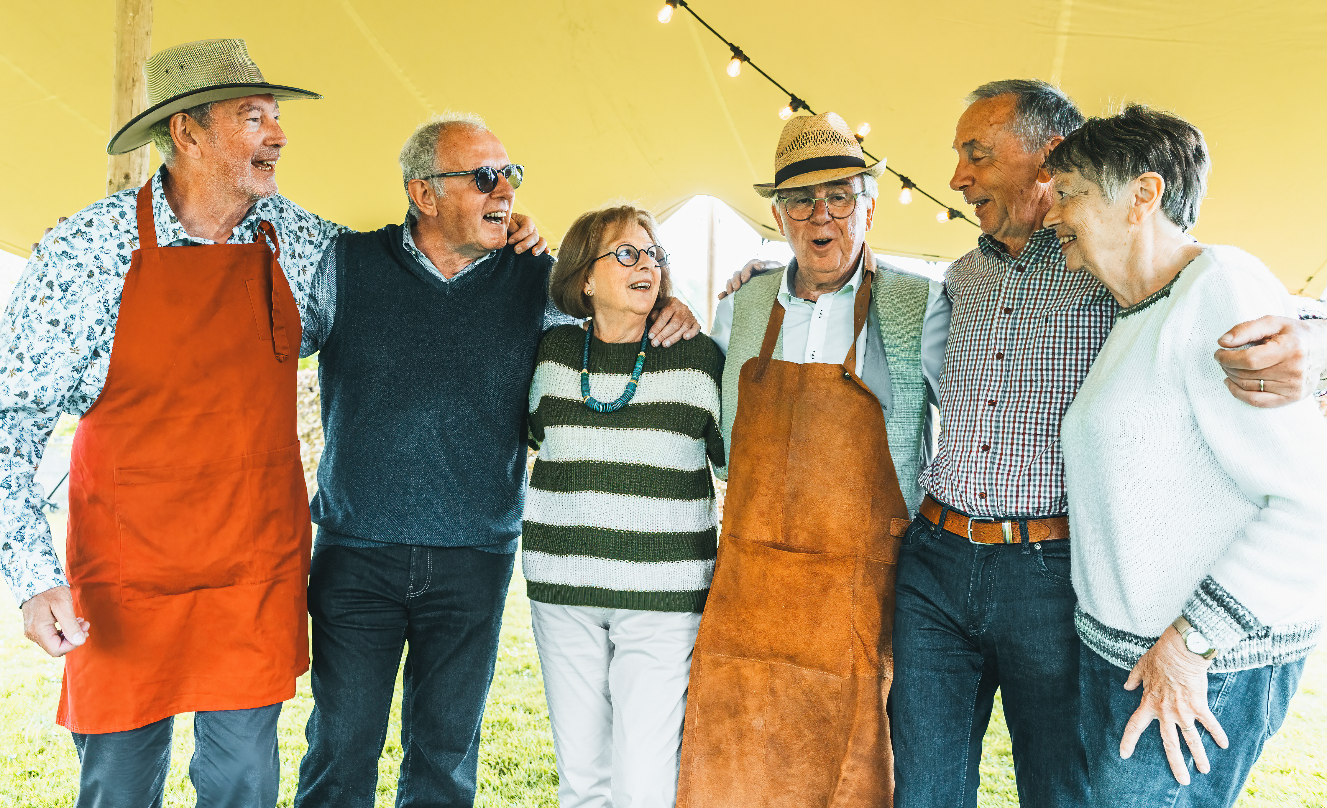 Five people arms around each other under a tent. Retirees in a top retirement state in U.S.