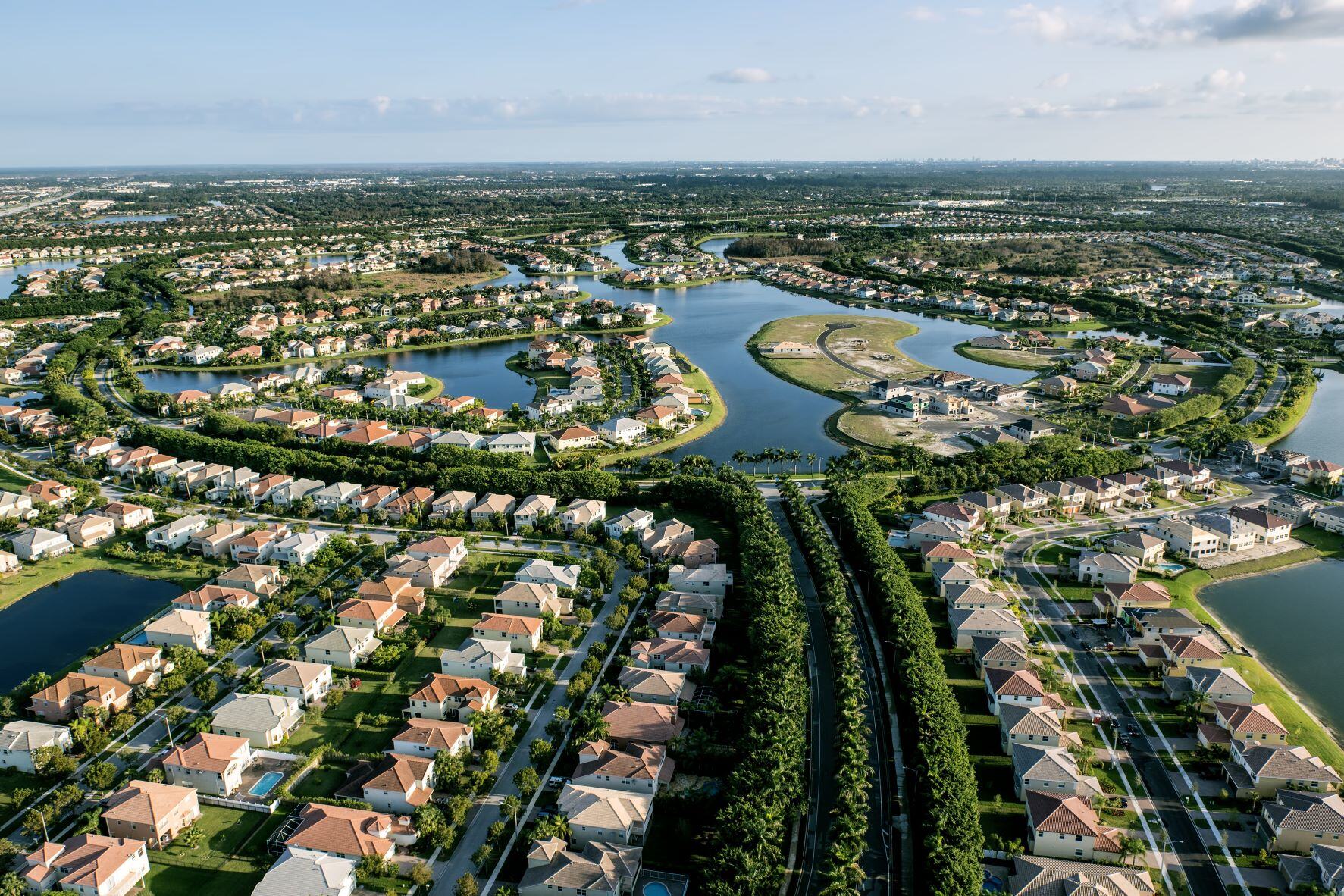 Aerial shot of a new home development in Florida. Lots of houses and waterways.